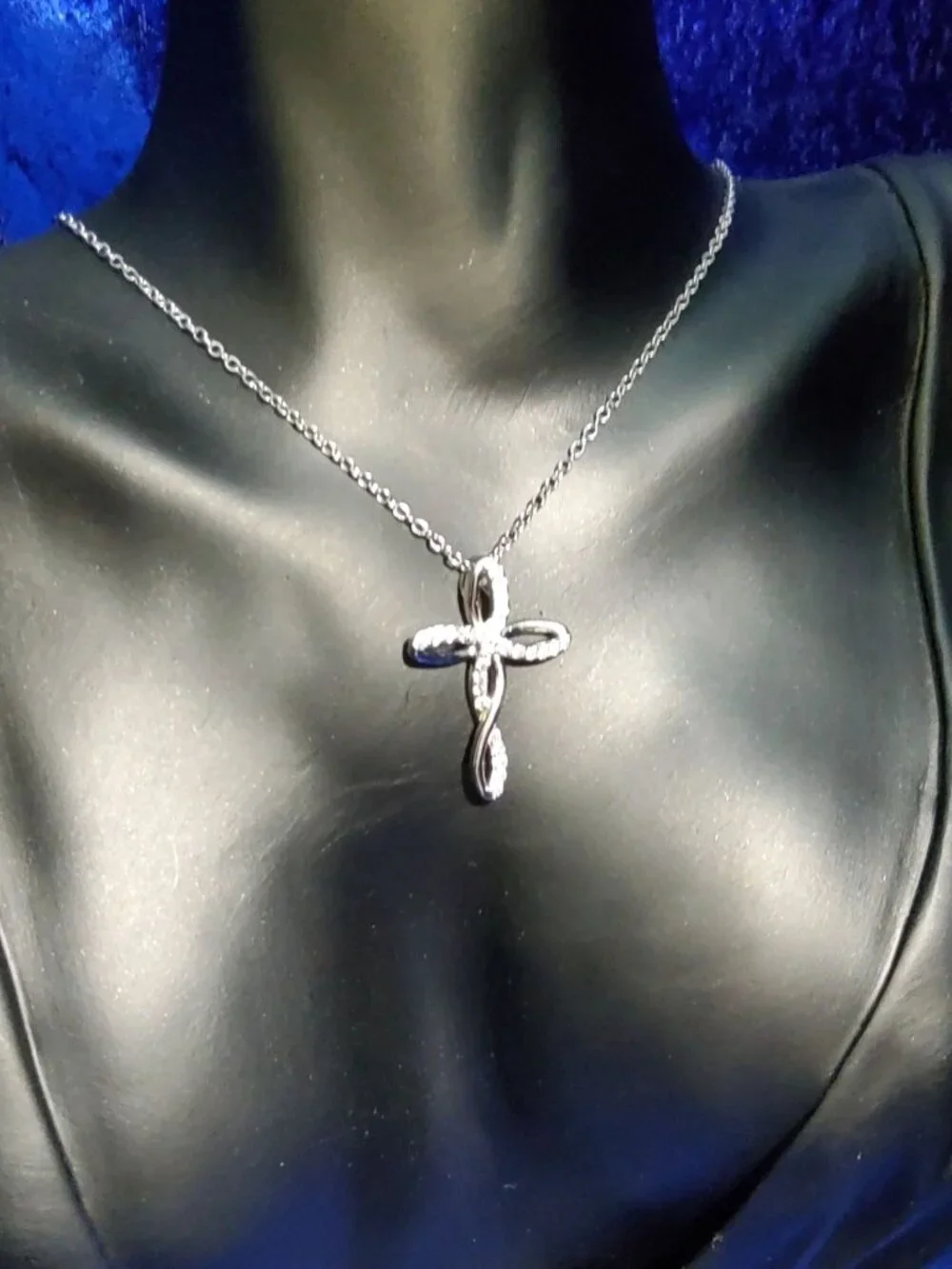 vintage Chrystal lined spiraled curled cross on a .925 sterling necklace